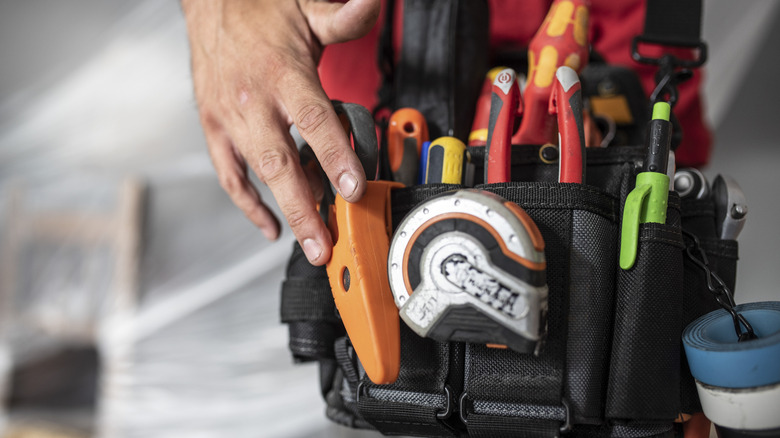 Person touching their tool belt