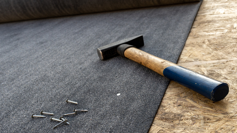 roofing felt with hammer and nails