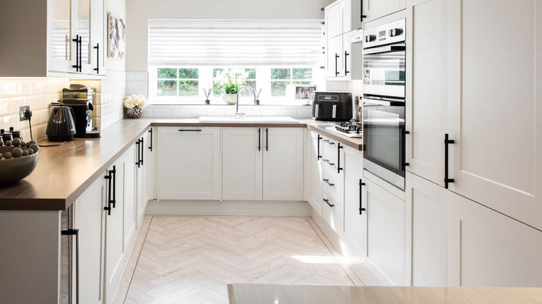 A small kitchen has multiple decor items and appliances on its counters.