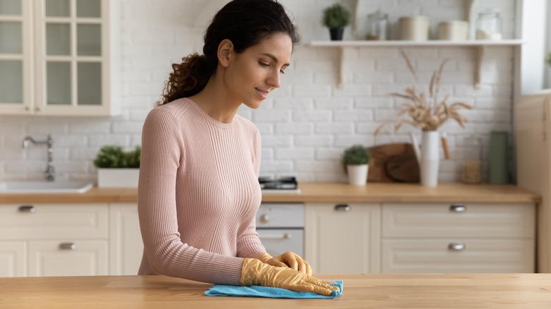 Woman wiping countertop