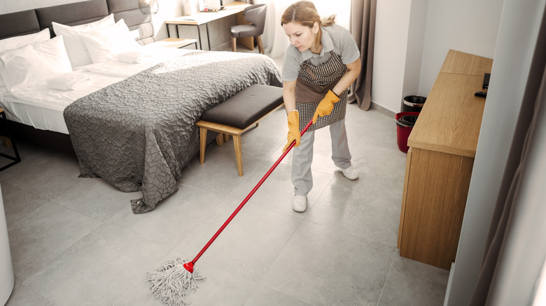 Person cleaning bedroom