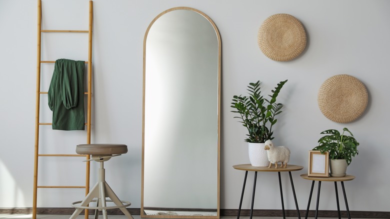 An arched standing mirror