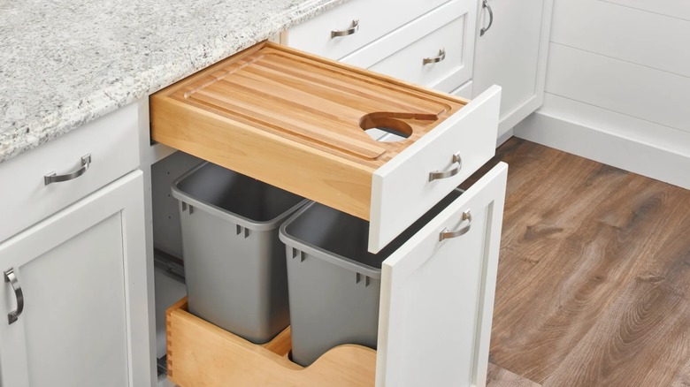 Rev-A-Shelf Cut-Out Cutting Board Drawer installed over pull-out trash cans