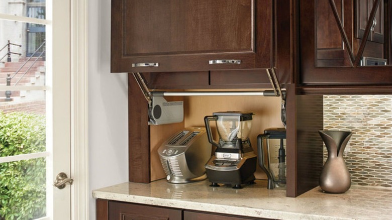 KraftMaid Wall Appliance Garage installed in traditional kitchen with wood cabinet doors