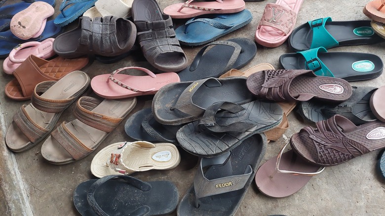 Summer sandals scattered on floor