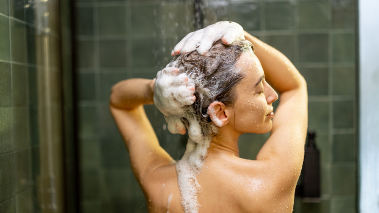 Woman washing hair in shower