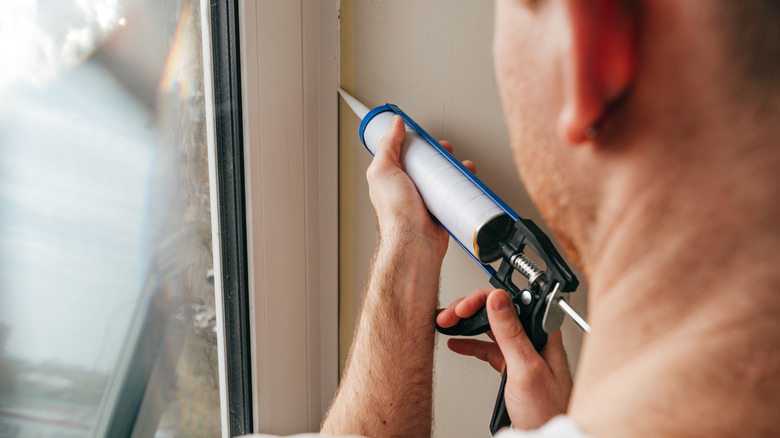 man using caulk