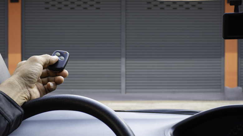 Person using garage opener remote