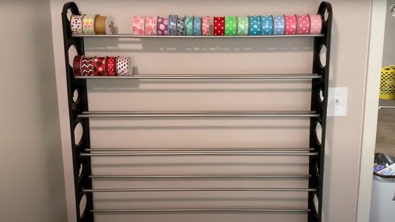 Ribbon rolls on metal shoe rack