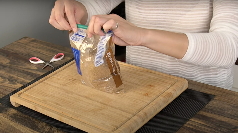 woman sealing brown sugar bag