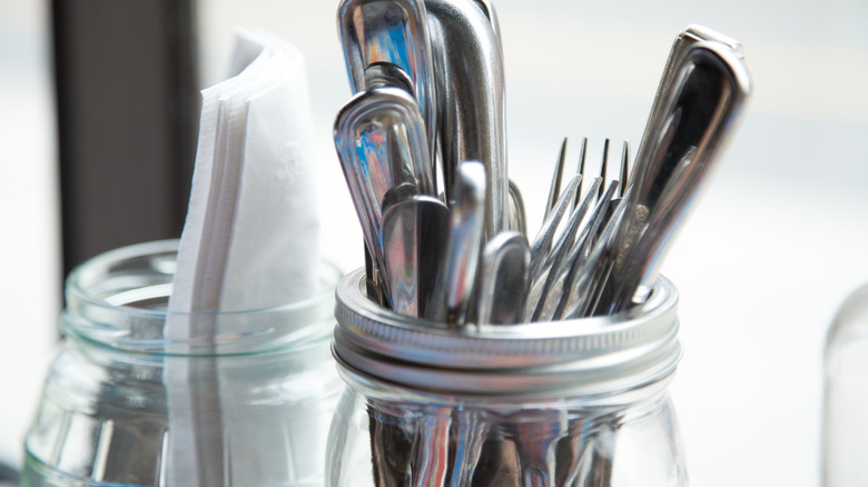 silverware and napkins in jar