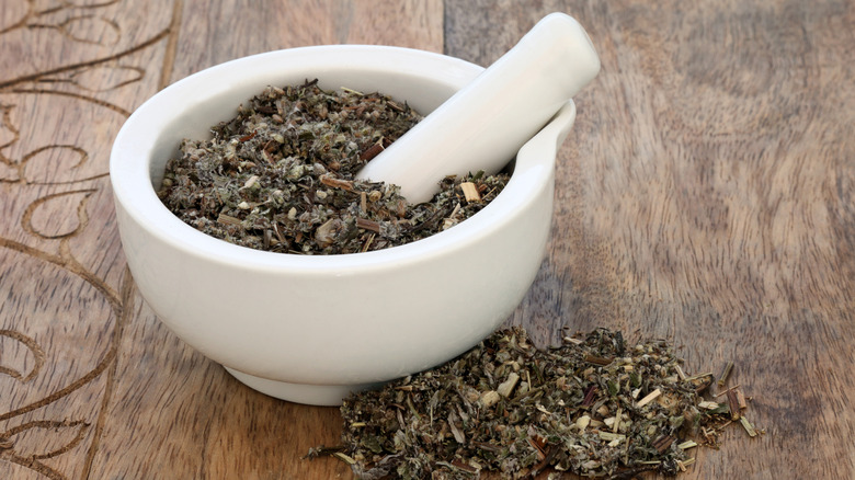 A mortar and pestle with dried mugwort