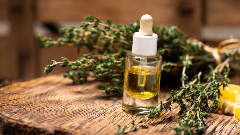 A thyme essential oil in a glass bottle