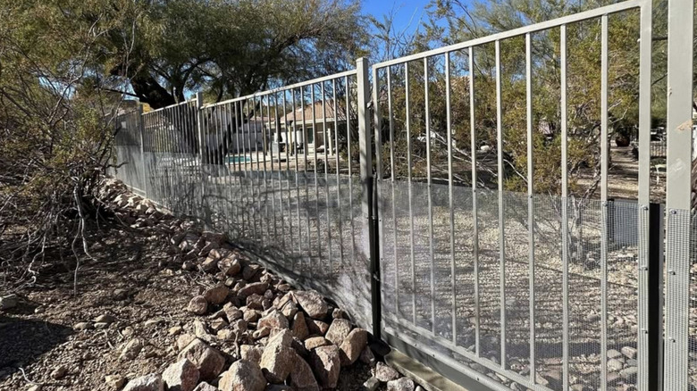 A snake-proof mesh installed on the side of a fence