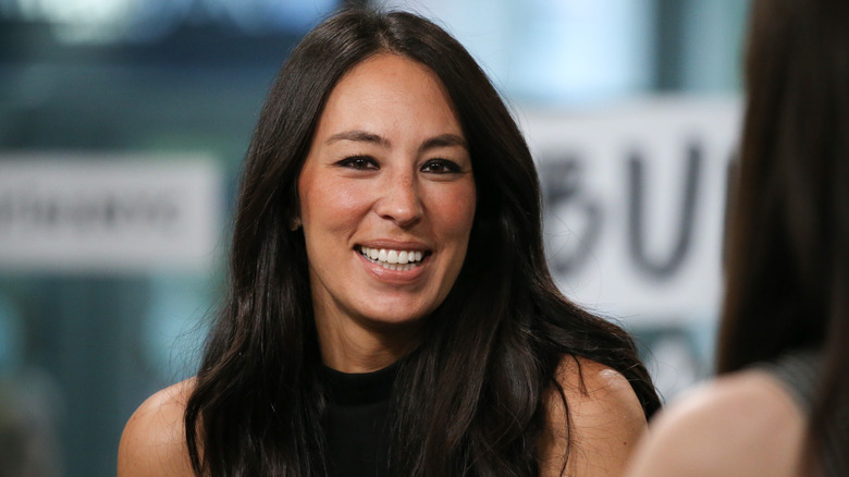 Joanna Gaines in front of blue backdrop