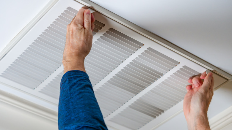 Person opening air vent 