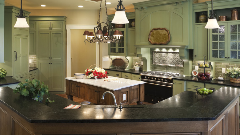 Green kitchen with a dark soapstone counter top