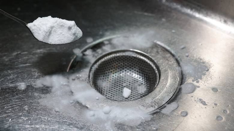 Sprinkling washing soda on drain