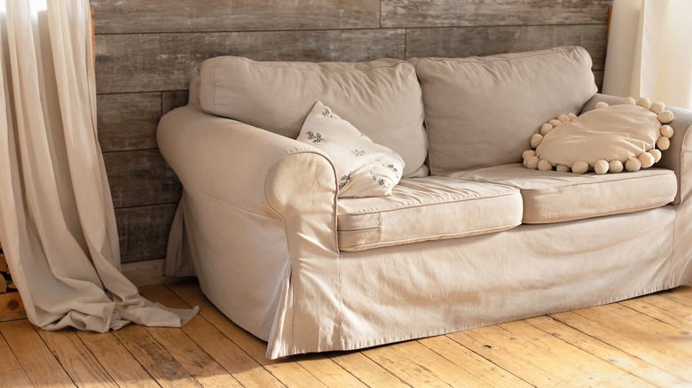 Tan couch cover on sofa