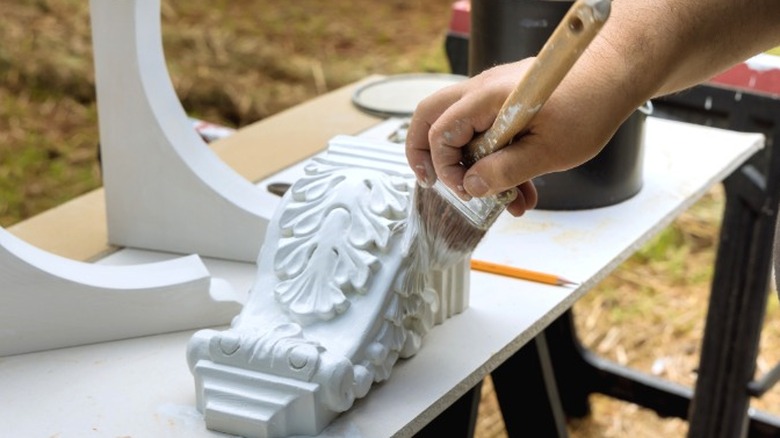 Hand painting decorative wood corbels with white paint