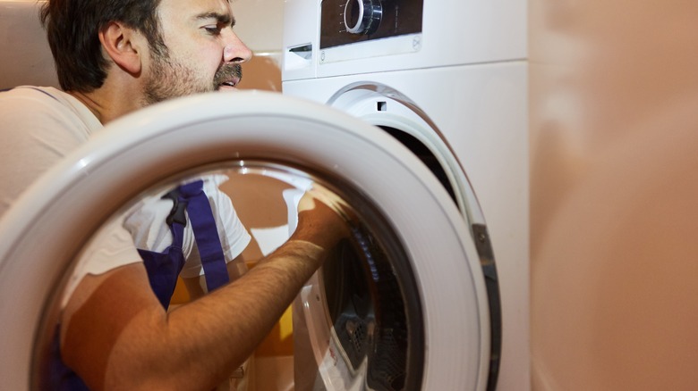 Man cleaning a dryer