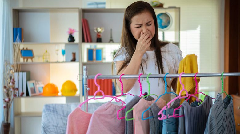 Woman holding a stinky shirt