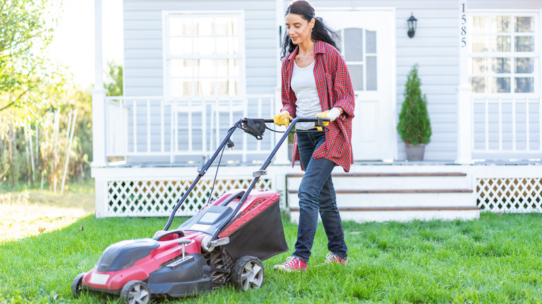 Woman mowing lawn