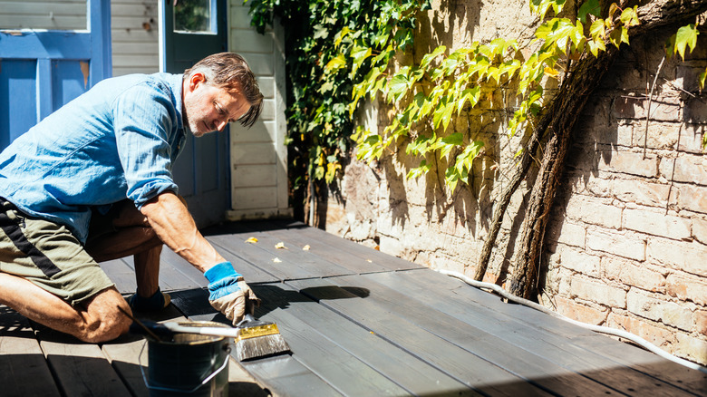 man painting deck