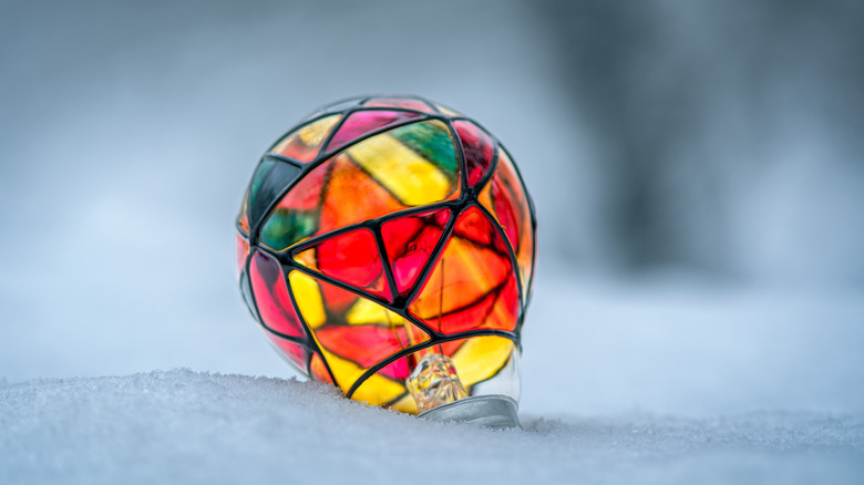 stained glass lightbulb in snow