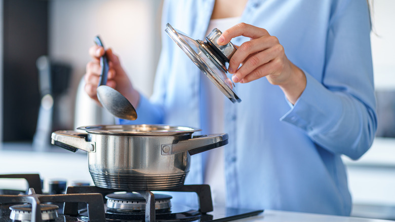 woman cooking with stainless steel