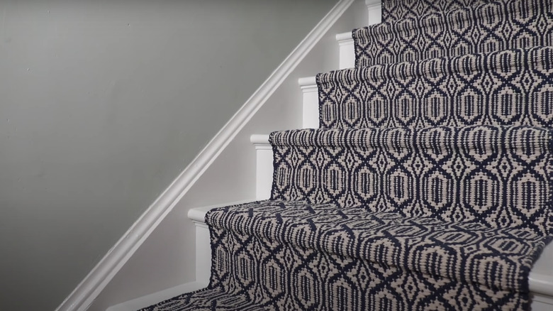 white stairs with patterned runner