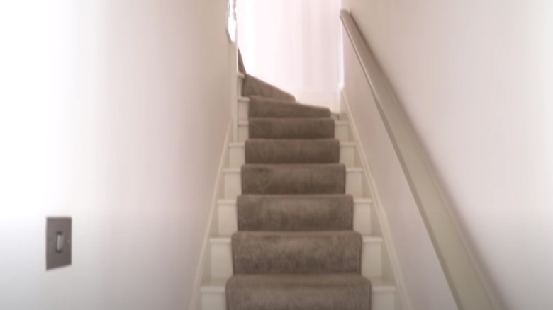 white stairs with torn runner