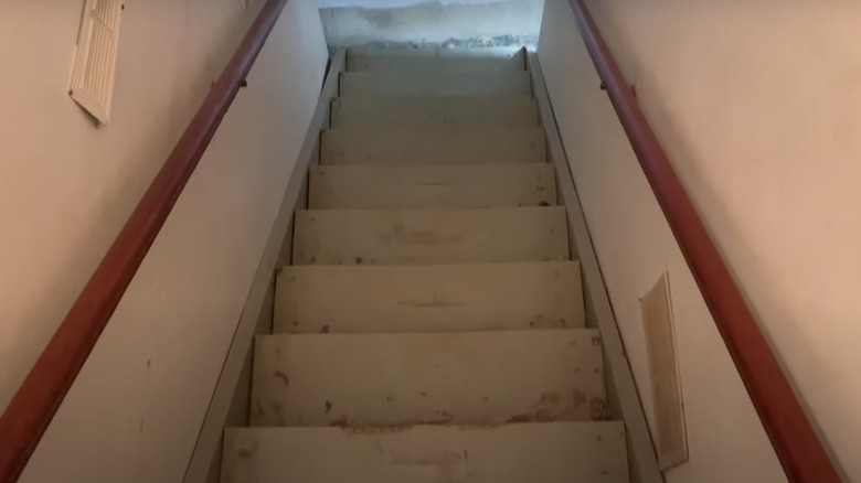 unfinished staircase with wooden railings