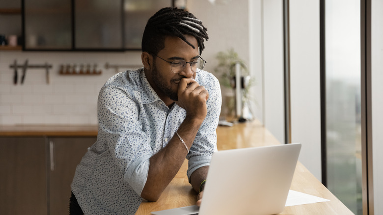 Person hunched over standing desk