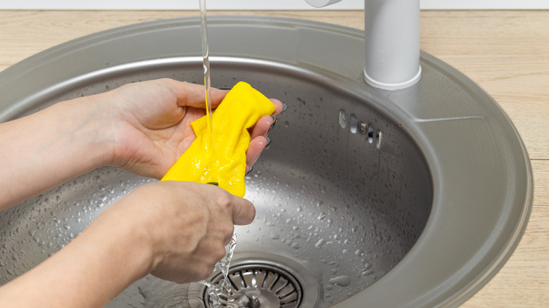 Person rinsing microfiber cloth