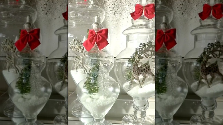 Apothecary jars filled with holiday decor