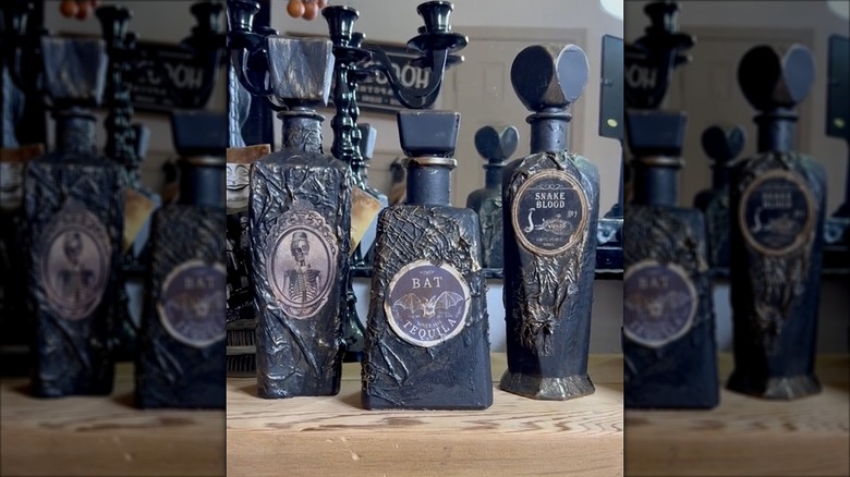 Black apothecary bottles with spooky labels