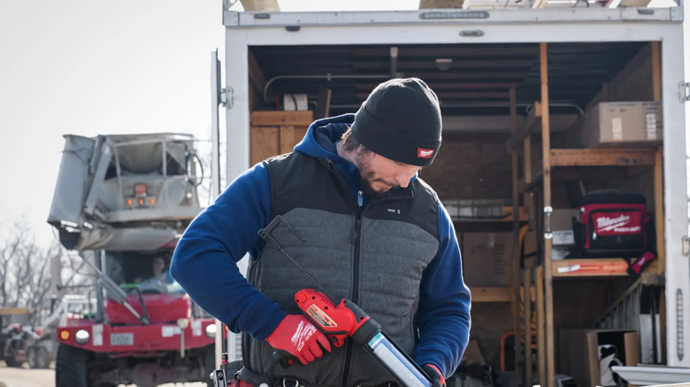 A man working outside and wearing Milwaukee heated vest