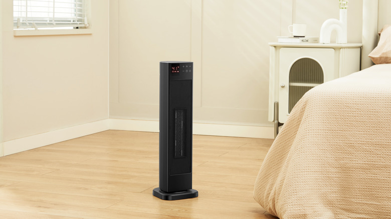 An image of the PELONIS tower heater in a bedroom.