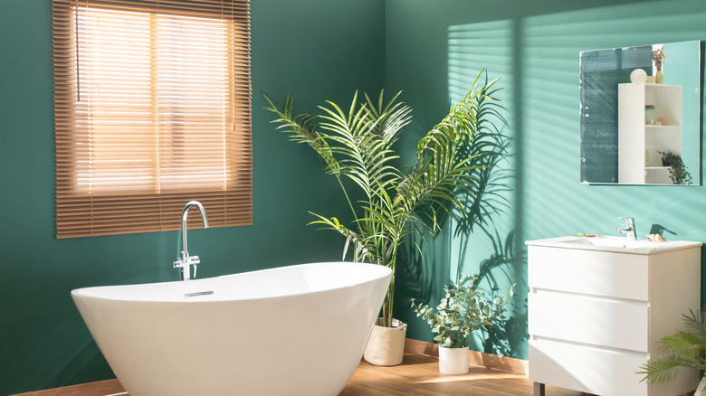 Bathroom with bright green walls and wood floors