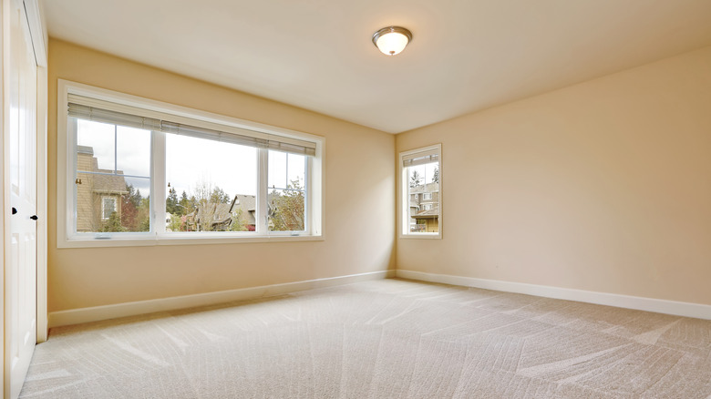 an empty beige bedroom