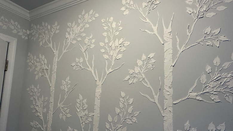 Gray wall with a contrasting tree stenciled design