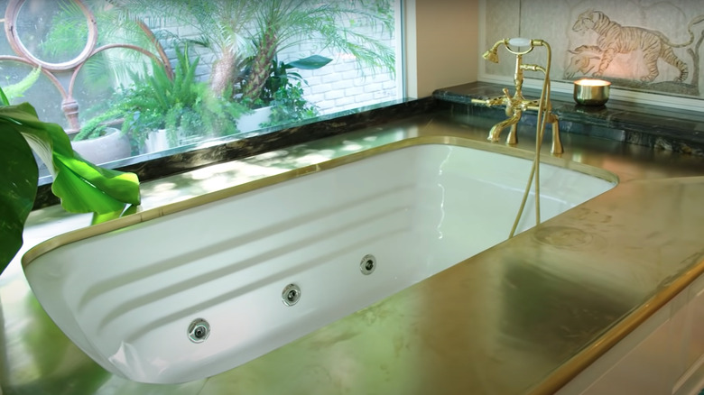 gold bathtub with television