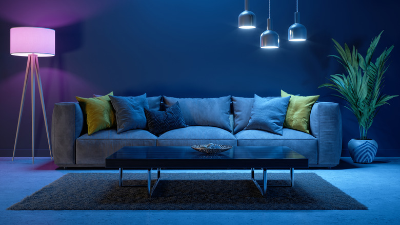 Monochromatic blue living room with plants and plush sofa.