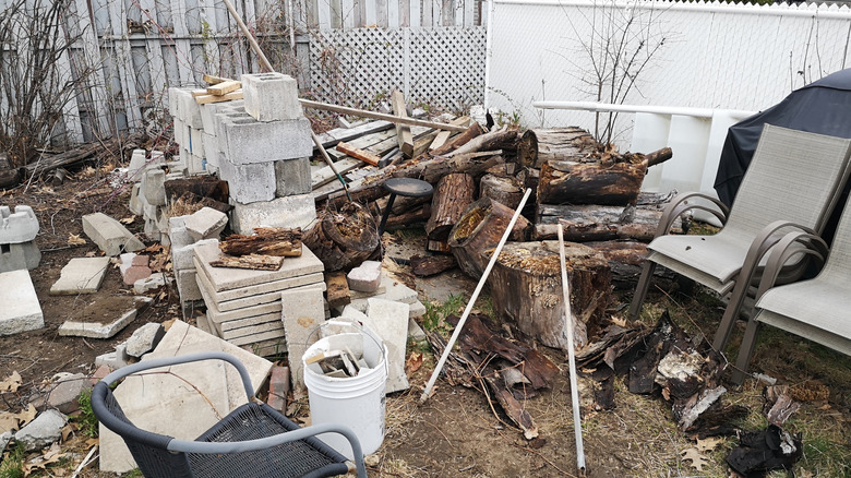 Piles of bricks and lumbar in yard