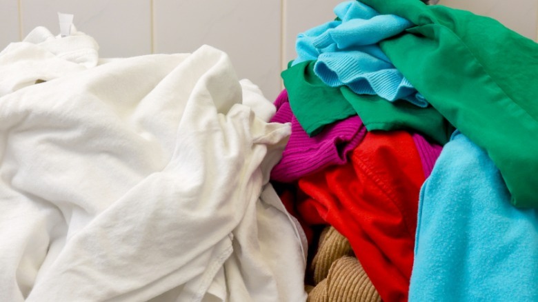 PIle of white laundry, pile of brightly colored laundry