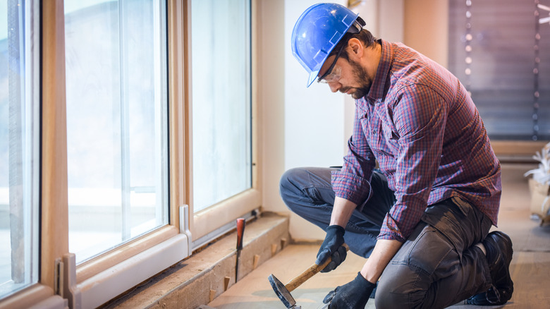 Man repairing hardwood floor