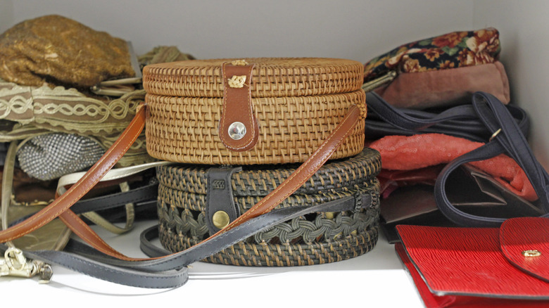 Stacks of handbags on a closet shelf