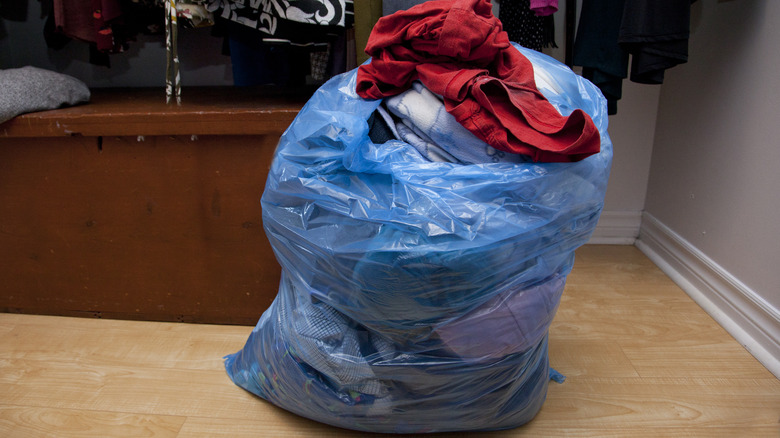 Clothes in a blue trash bag