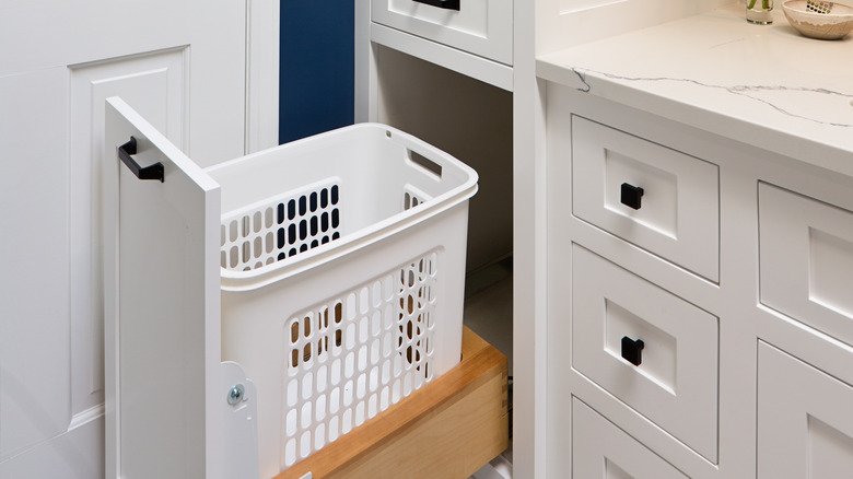 a pull out hamper in cabinet